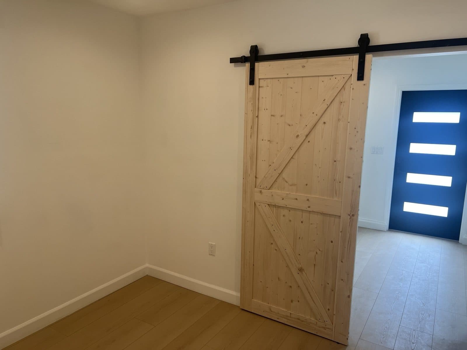 Sliding barn door separating the bedroom from the living area