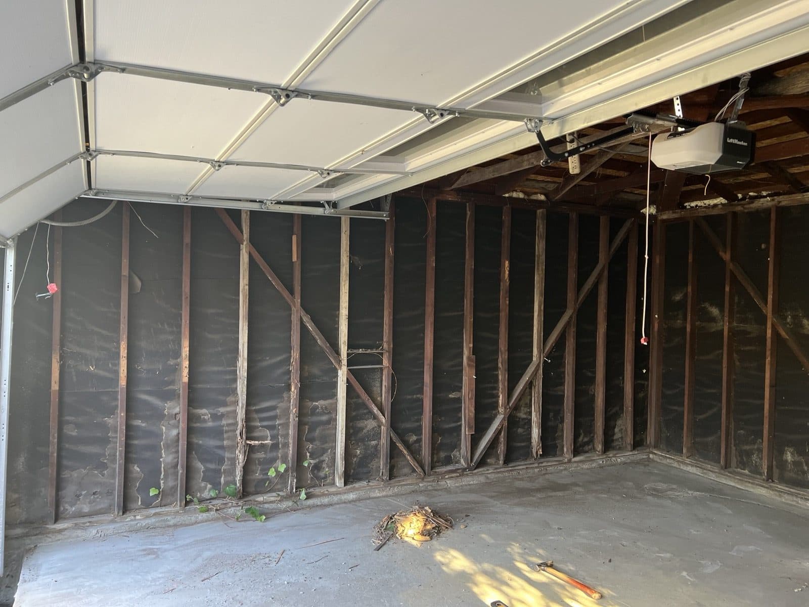 Garage interior stripped to the framing during demolition