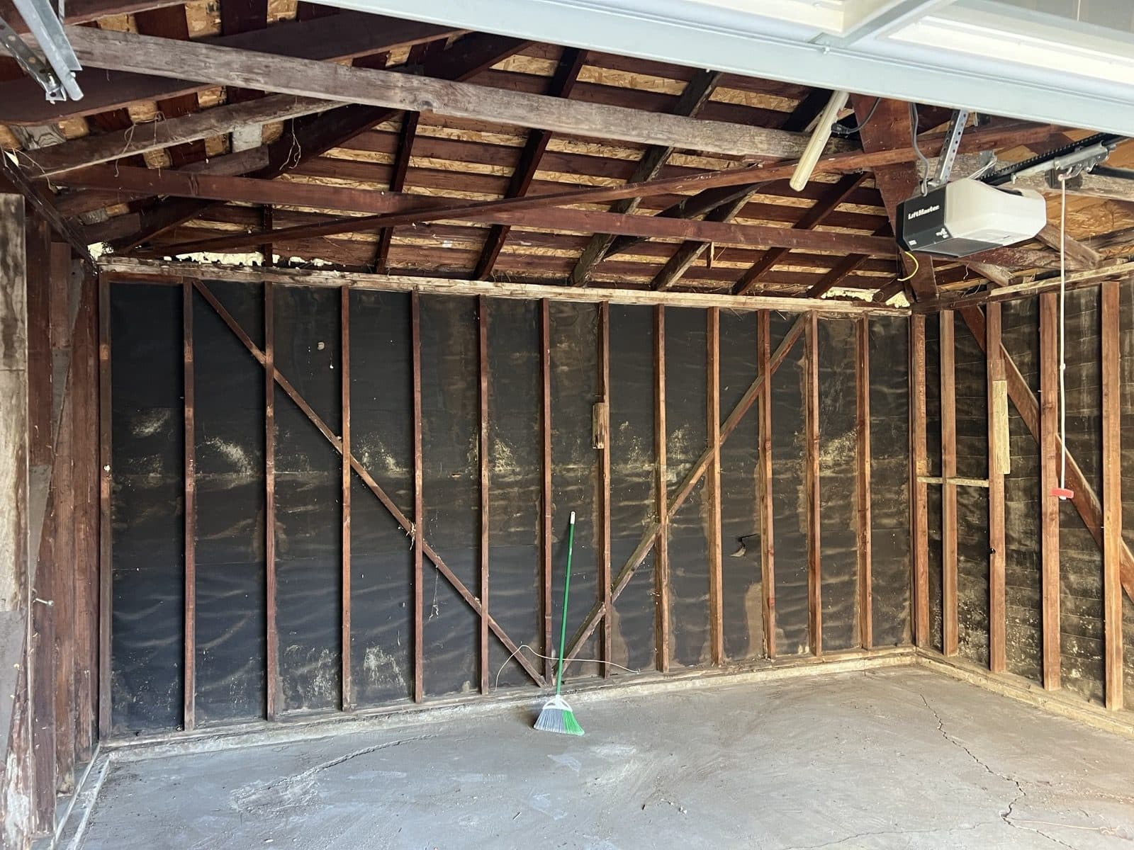 Original rafters and wall framing exposed after demolition
