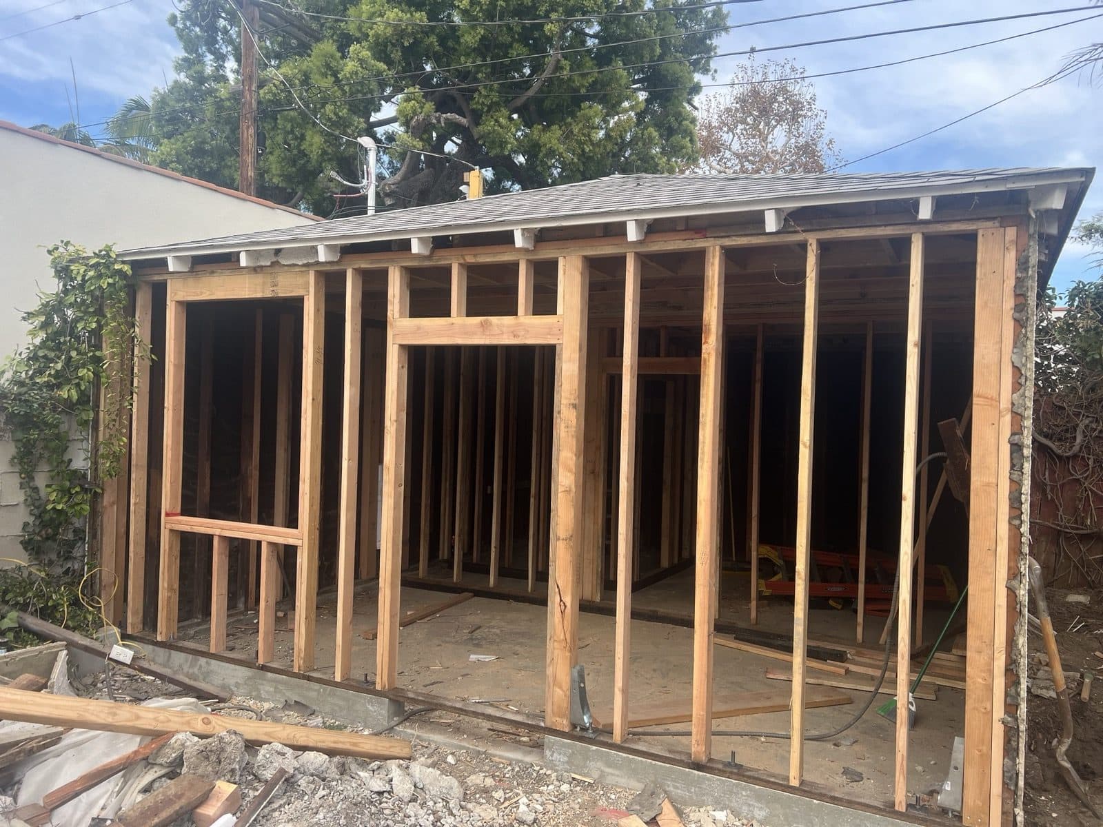New wall framing with door and window openings in the converted garage