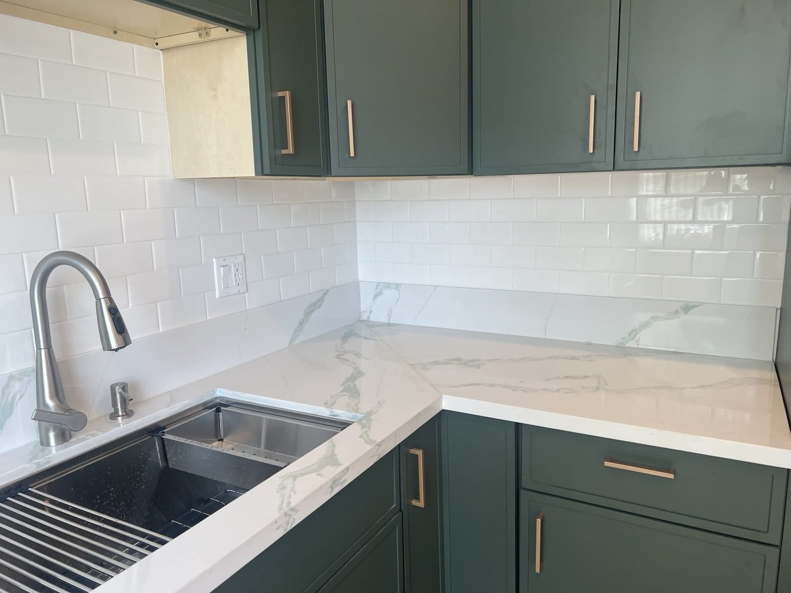 Quartz counter, stainless sink, and white subway tile backsplash